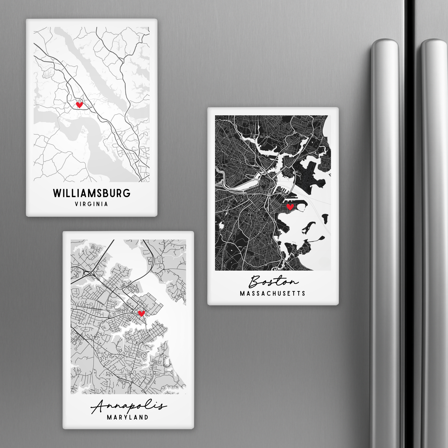 Three city map magnets on a refrigerator, featuring Williamsburg, Virginia; Boston, Massachusetts; and Annapolis, Maryland.