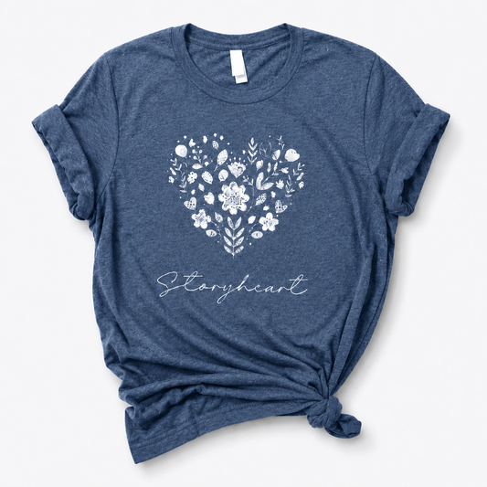 Blue t-shirt with floral heart design and 'Storyheart' text on a white background