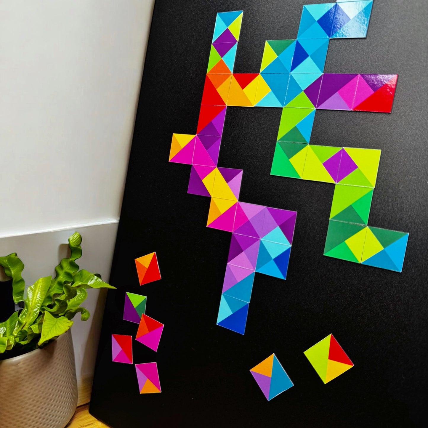 Scattered colored squares for magnetic art designs displays on a magnet board