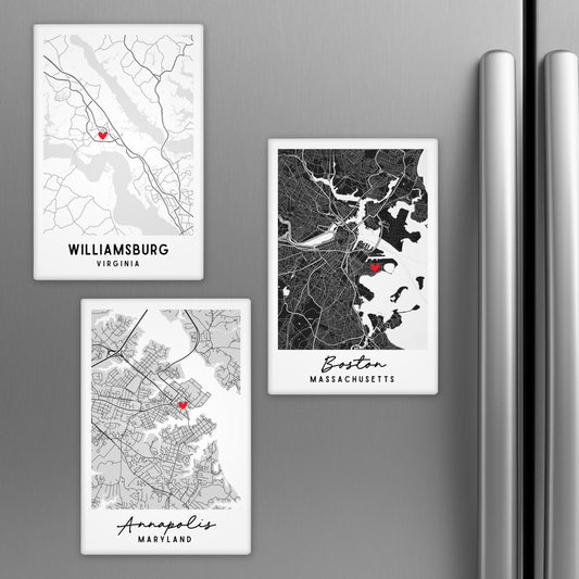 Three city map magnets on a refrigerator, featuring Williamsburg, Virginia; Boston, Massachusetts; and Annapolis, Maryland.