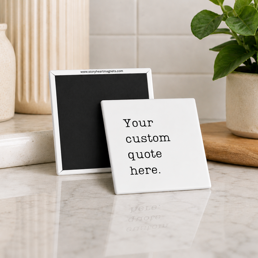 Two small framed signs on a marble surface with a plant and decorative items in the background.